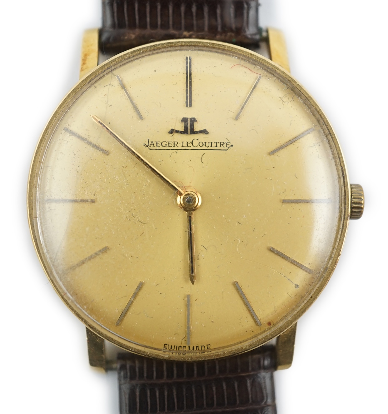 A gentleman's 18ct gold Jaeger LeCoultre manual wind dress wrist watch, on an associated strap